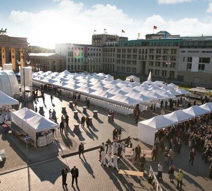 White folding gazebos 8x4 and 6x4 m at a large event with many people at Alexanderplatz in Berlin