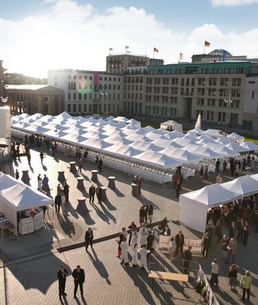 White folding gazebos 8x4 and 6x4 m at a large event with many people at Alexanderplatz in Berlin